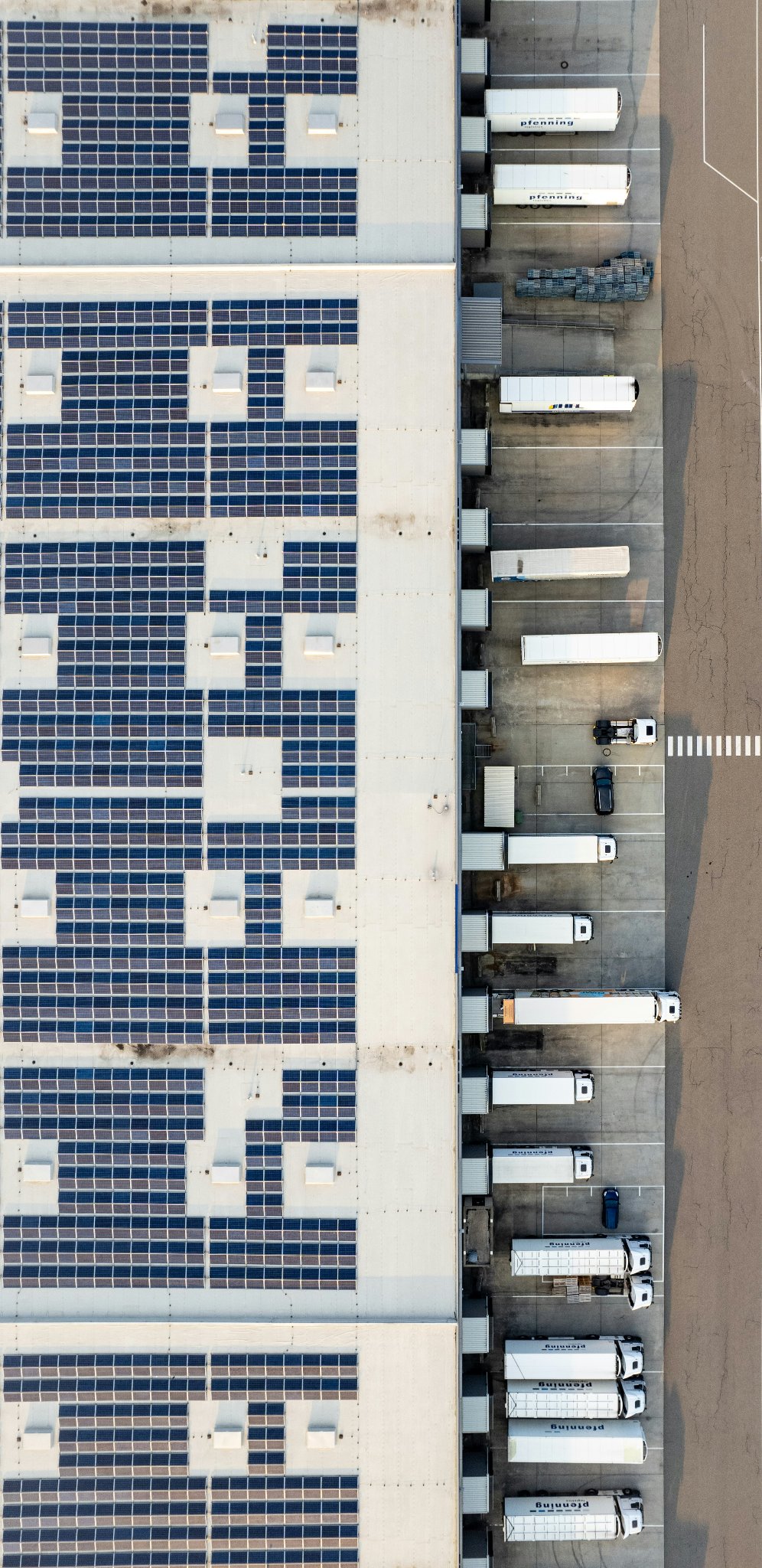 Aerial view of a logistics park with solar panels and truck bays